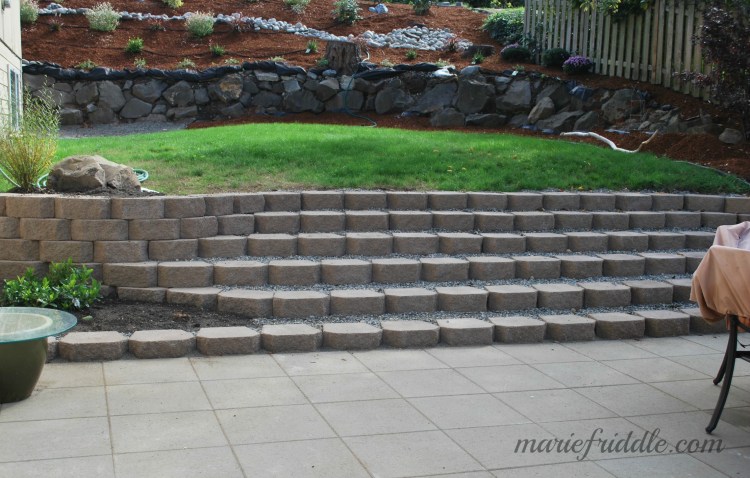 We still have work to do on the back wall. FIRST, removing the concrete pieces my husband thought would be good to use as filler.... REALLY???? But still a big improvement.